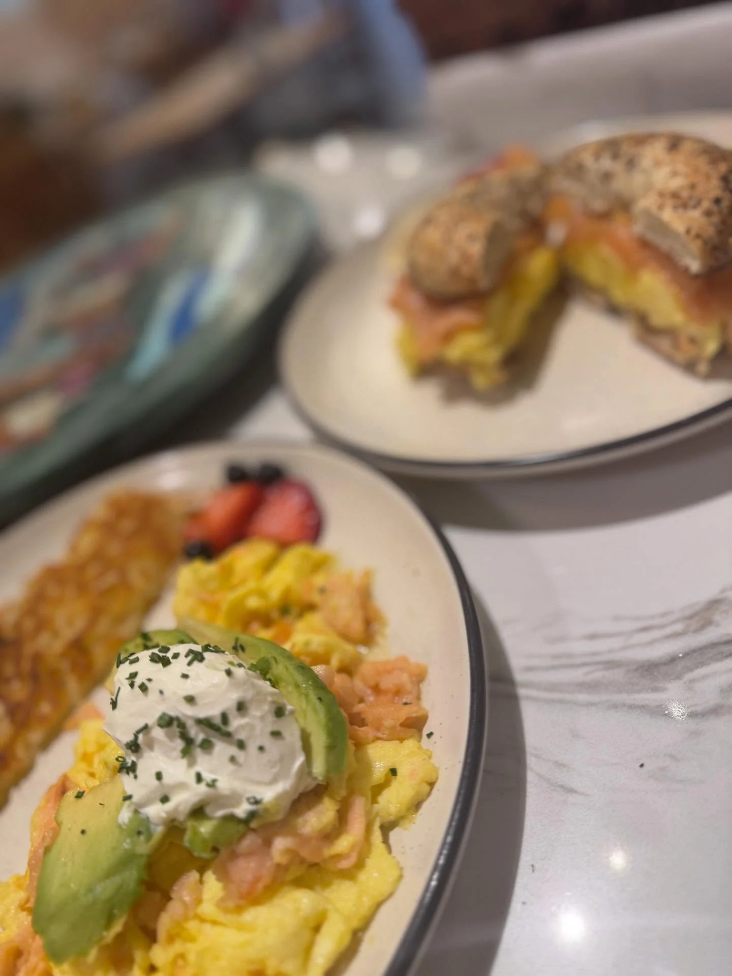 Avocado toast on sourdough with eggs, lime crema, and hash browns